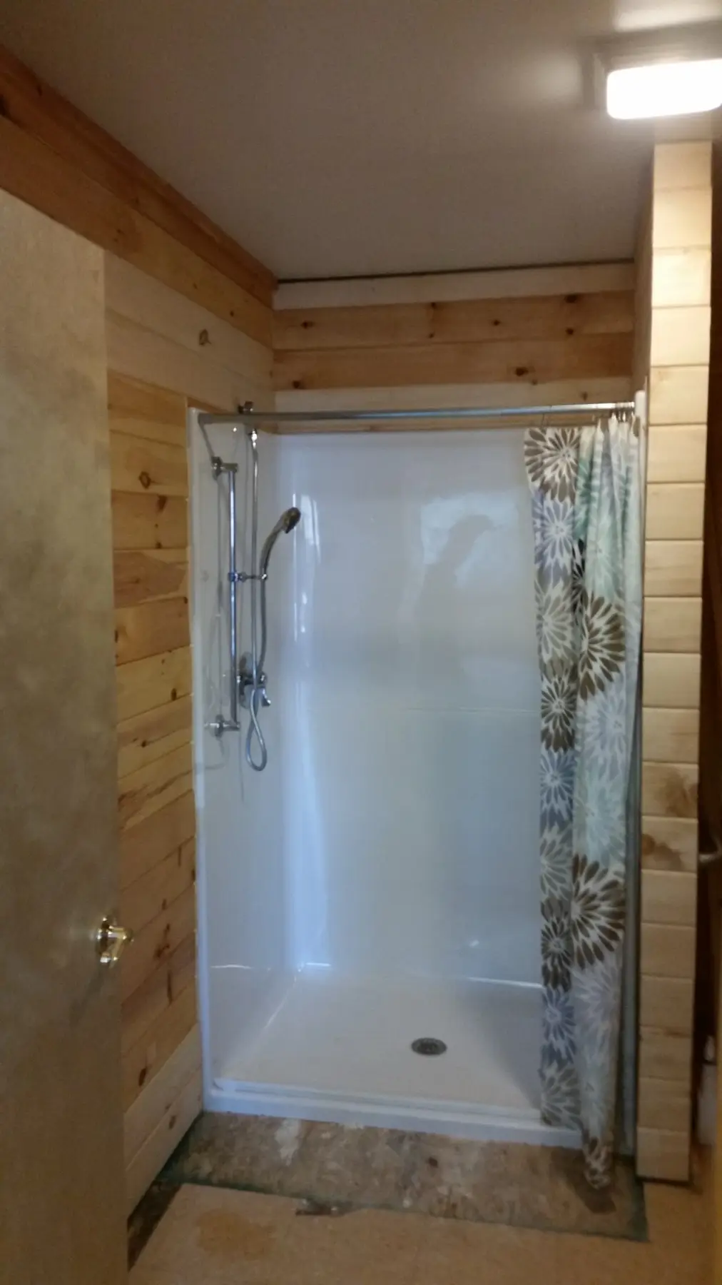 Bathtub shower in rustic cabin bathroom